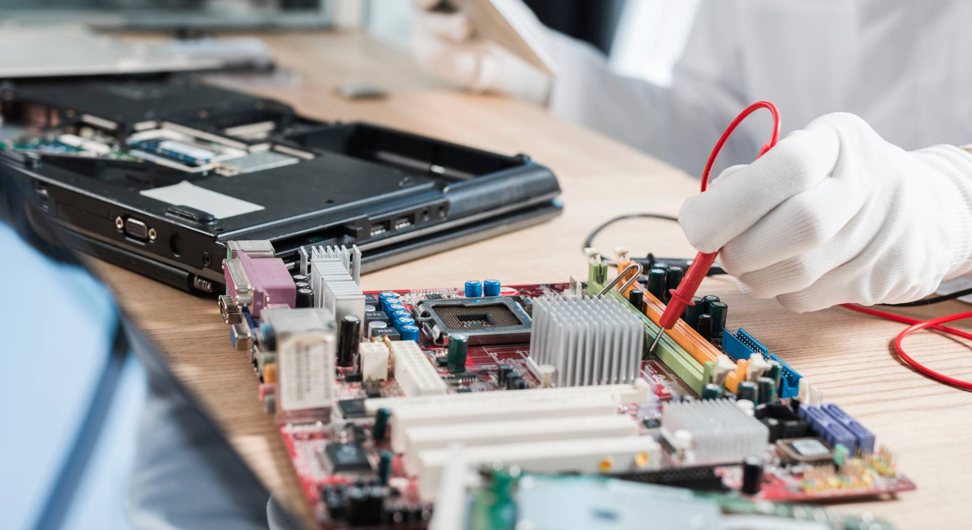 technician-examining-mother-board technician examining mother board 1